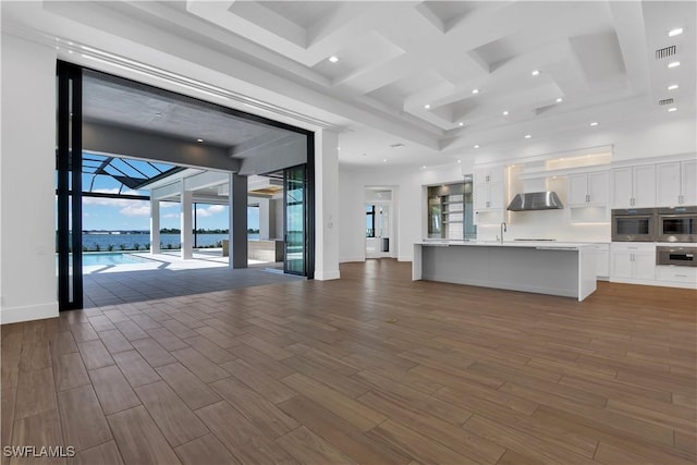 unfurnished living room featuring a water view