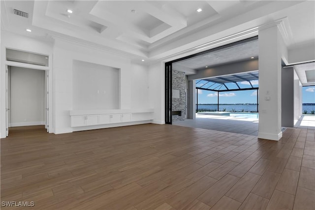 unfurnished living room with a fireplace, crown molding, and coffered ceiling