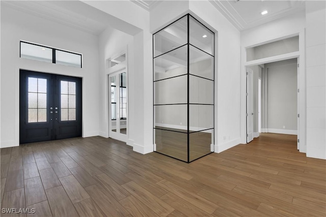 entryway with crown molding, french doors, and wood-type flooring