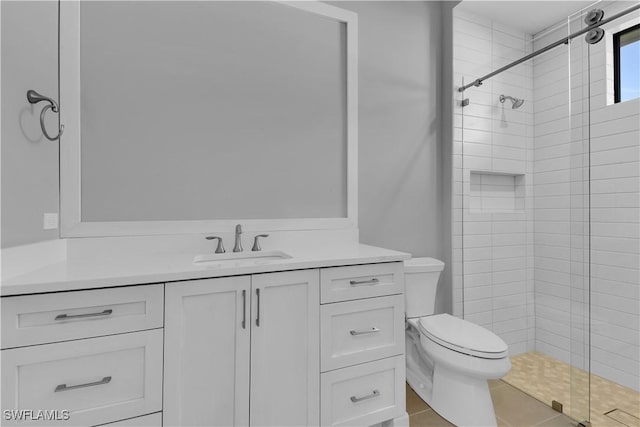 bathroom with vanity, toilet, and a shower with shower door