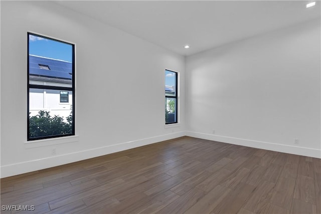 empty room with hardwood / wood-style floors