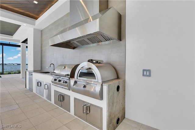 exterior space featuring tasteful backsplash, wall chimney exhaust hood, sink, wooden ceiling, and light tile patterned flooring