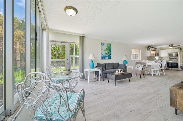 living room featuring a textured ceiling and ceiling fan