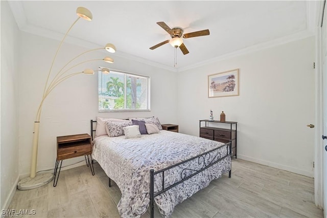 bedroom featuring light hardwood / wood-style flooring, ceiling fan, and crown molding