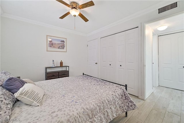 bedroom featuring ceiling fan, light hardwood / wood-style flooring, and ornamental molding