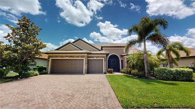 view of front of house with a front yard and a garage