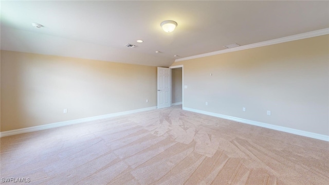 carpeted spare room featuring crown molding