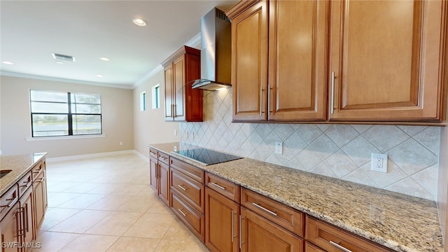 kitchen featuring black electric stovetop, wall chimney exhaust hood, ornamental molding, light tile patterned floors, and light stone counters