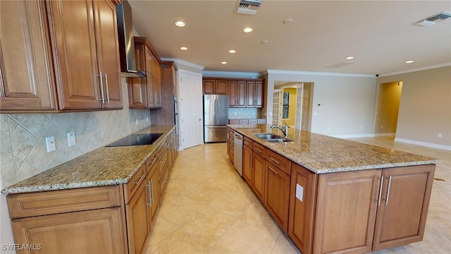 kitchen with light stone countertops, sink, stainless steel appliances, a spacious island, and ornamental molding