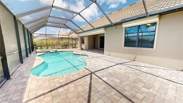 view of pool with glass enclosure, an in ground hot tub, and a patio