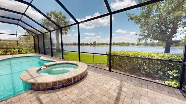 view of swimming pool featuring an in ground hot tub, a patio, a water view, and glass enclosure