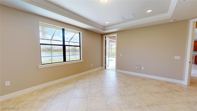 unfurnished room featuring a tray ceiling, crown molding, and light tile patterned floors