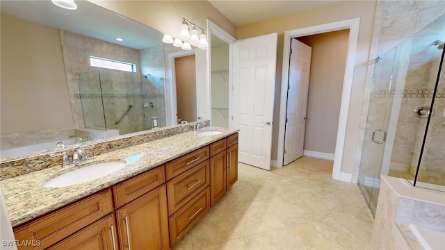 bathroom featuring vanity and shower with separate bathtub