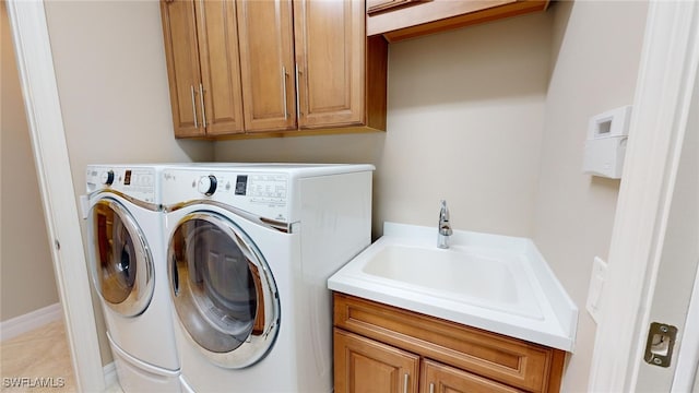 laundry room featuring cabinets, separate washer and dryer, light tile patterned flooring, and sink