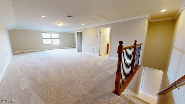 carpeted empty room with ornamental molding and lofted ceiling