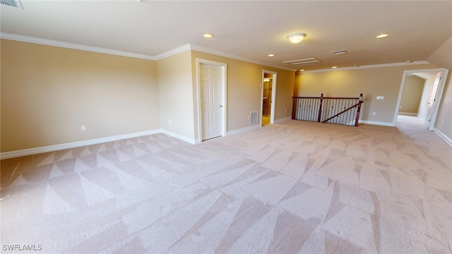 spare room featuring ornamental molding and light carpet