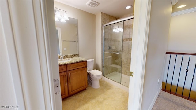 bathroom featuring tile patterned floors, vanity, a shower with shower door, and toilet