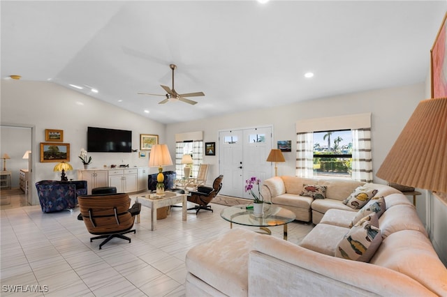 tiled living room featuring ceiling fan and lofted ceiling