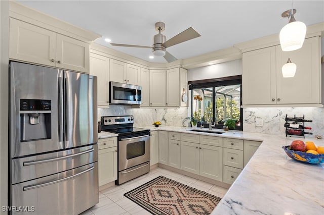 kitchen featuring decorative backsplash, ceiling fan, hanging light fixtures, and appliances with stainless steel finishes