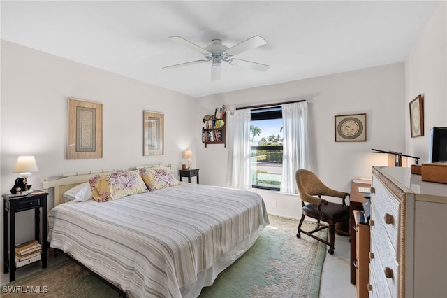 bedroom with ceiling fan and dark tile patterned flooring