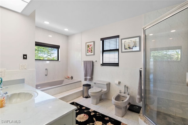 full bathroom with vanity, a bidet, tile patterned floors, toilet, and independent shower and bath