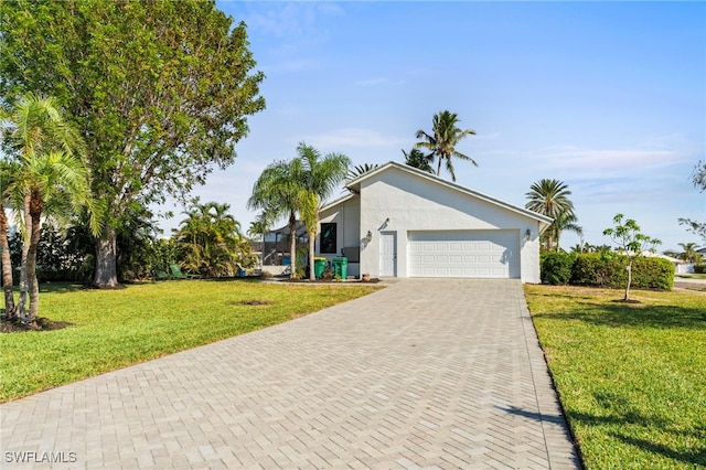 single story home featuring a garage and a front lawn