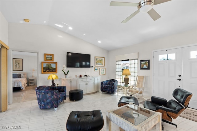 tiled living room with ceiling fan and lofted ceiling