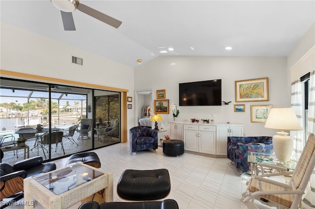 tiled living room featuring a wealth of natural light, lofted ceiling, and ceiling fan