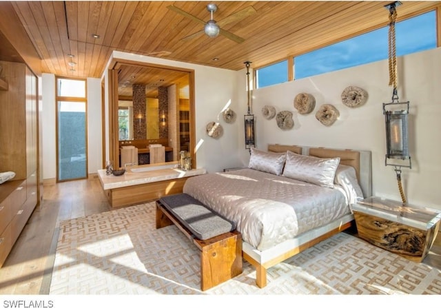 bedroom featuring light hardwood / wood-style flooring and wood ceiling