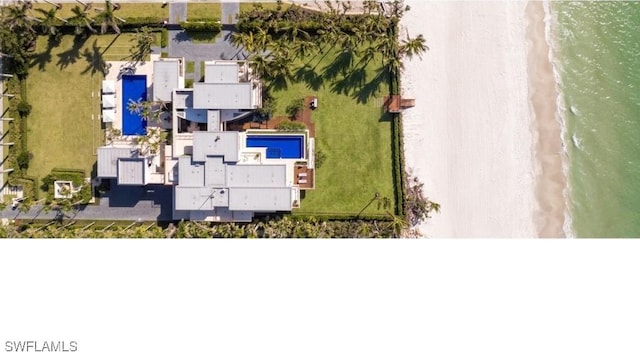 drone / aerial view with a water view and a beach view
