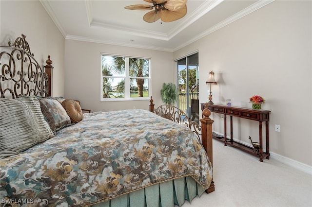 carpeted bedroom featuring access to outside, a raised ceiling, ceiling fan, and ornamental molding