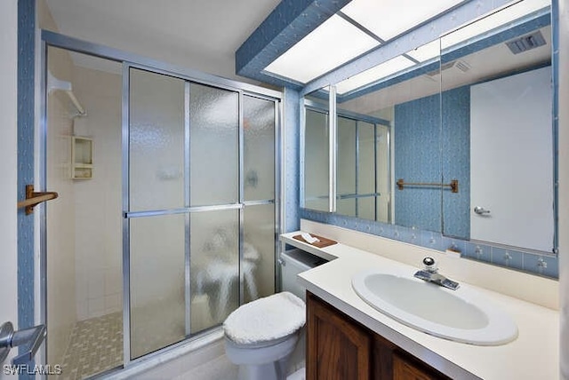 bathroom featuring vanity, toilet, and walk in shower