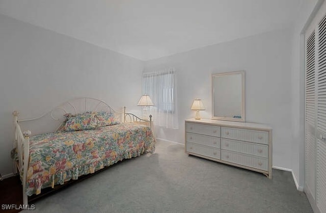 carpeted bedroom with a closet