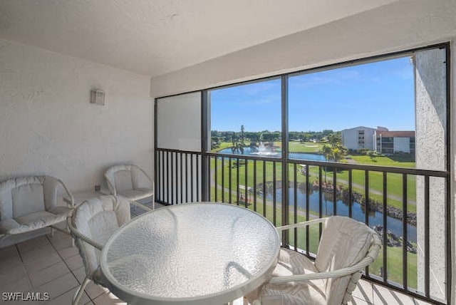 sunroom with a water view and a healthy amount of sunlight