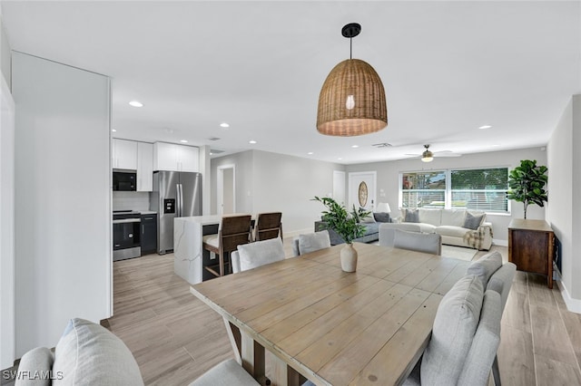 dining room featuring ceiling fan and light wood-type flooring