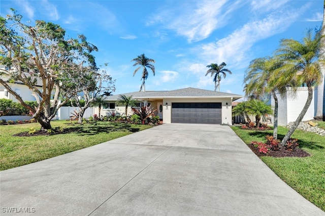 ranch-style house with a front yard and a garage