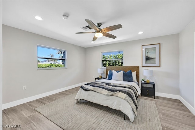 bedroom with ceiling fan and light wood-type flooring