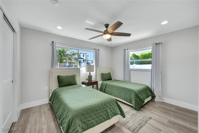 bedroom with wood-type flooring, a closet, and ceiling fan