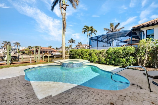 view of pool with glass enclosure, an in ground hot tub, and a water view