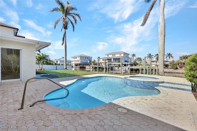 view of swimming pool with an in ground hot tub