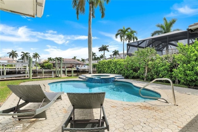 view of swimming pool featuring an in ground hot tub and a patio area