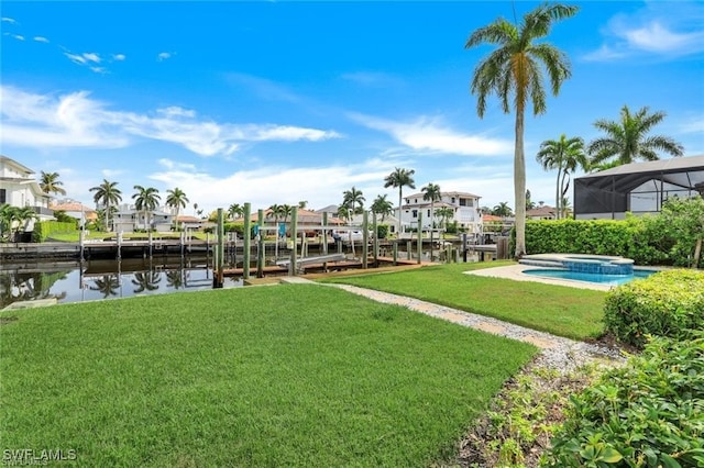 view of yard featuring a dock, a water view, and an in ground hot tub