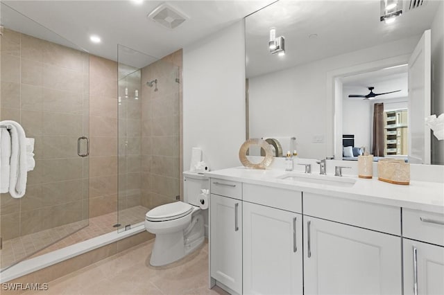 bathroom featuring a shower with shower door, tile patterned flooring, vanity, ceiling fan, and toilet