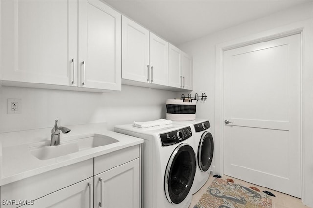 laundry room featuring cabinets, sink, and washing machine and dryer