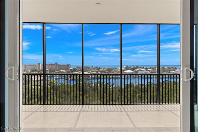 unfurnished sunroom with a water view