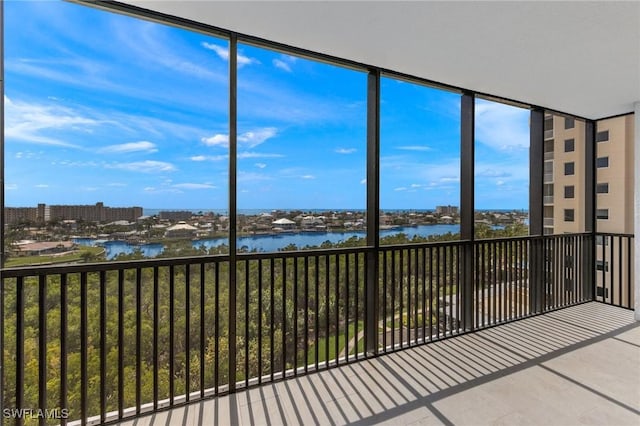 unfurnished sunroom featuring a water view