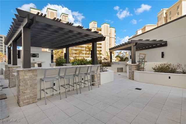 view of patio with a pergola and an outdoor bar