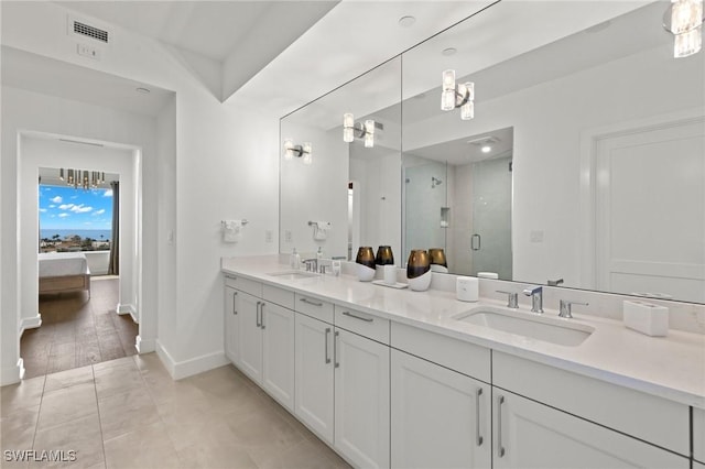 bathroom with vanity, tile patterned floors, and a shower with door