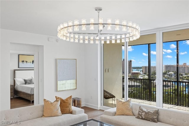 living room with hardwood / wood-style floors and a chandelier