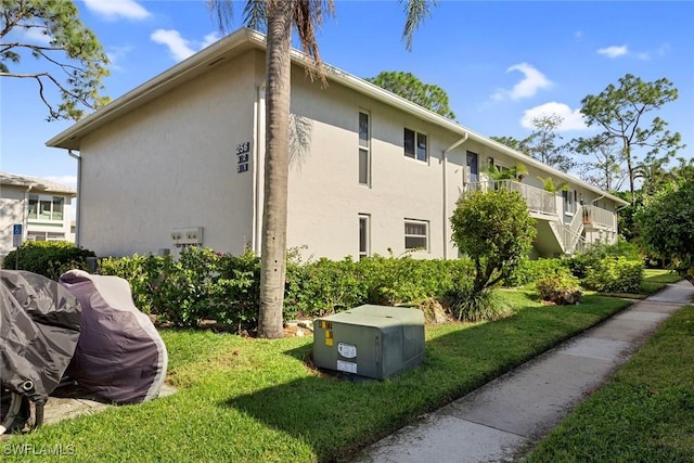 view of side of home with a yard